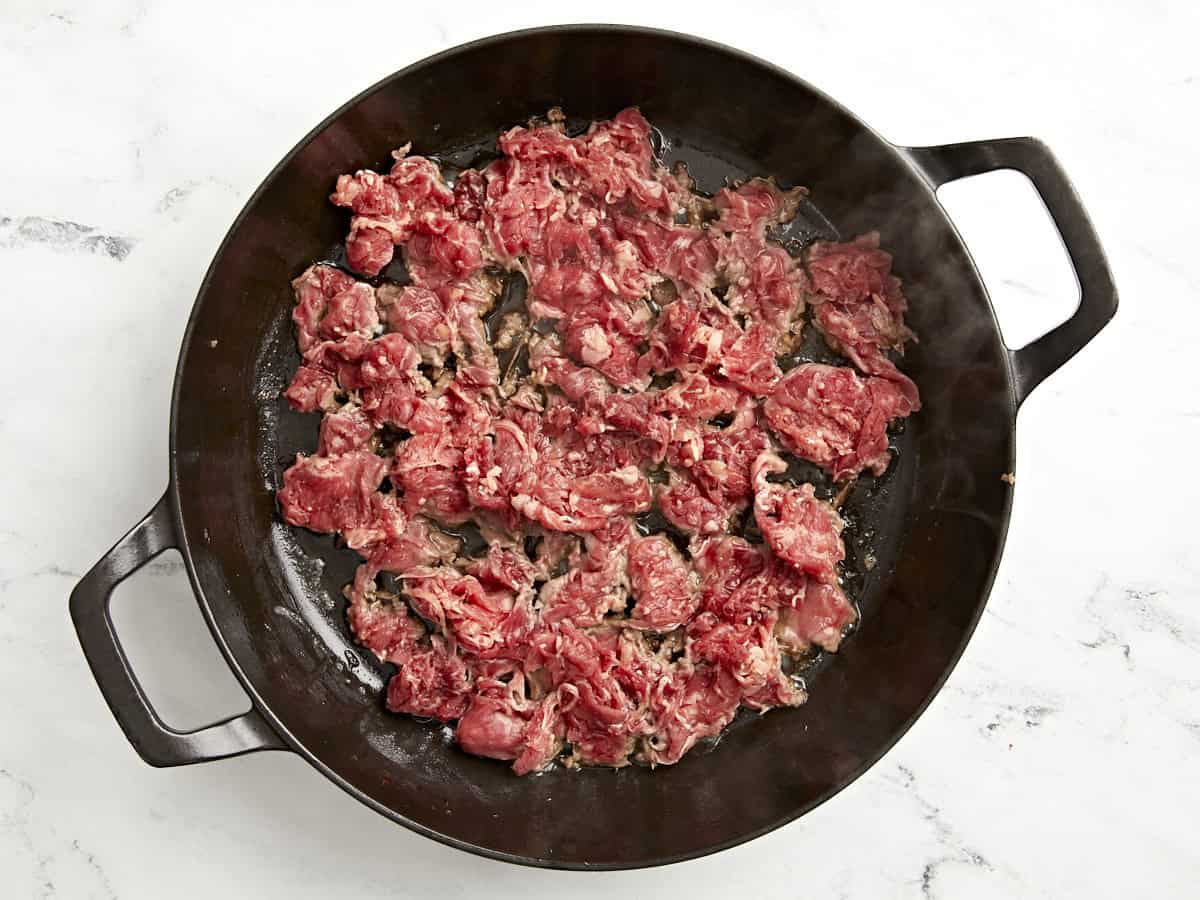 Shaved beef added to skillet