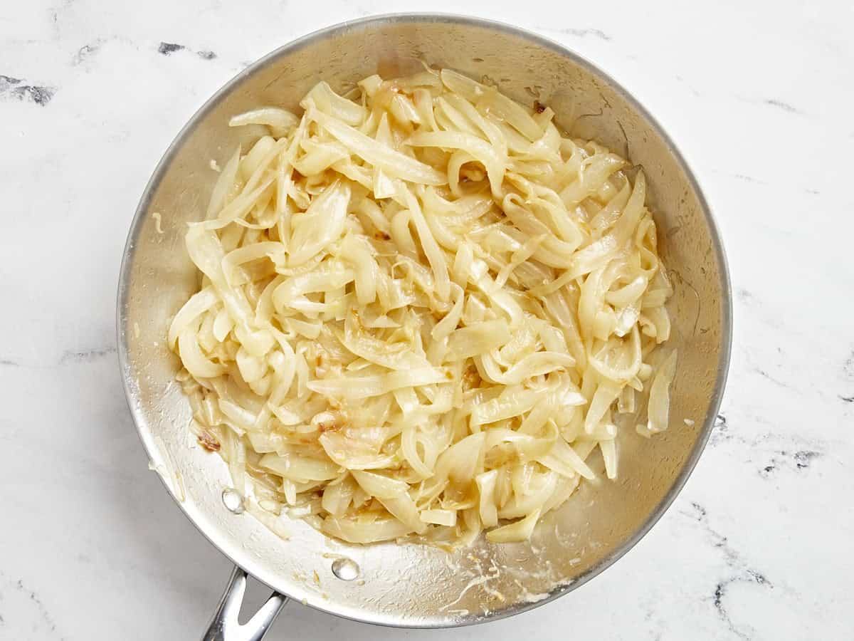 Sliced onions cooking in a pan after 25 minutes.