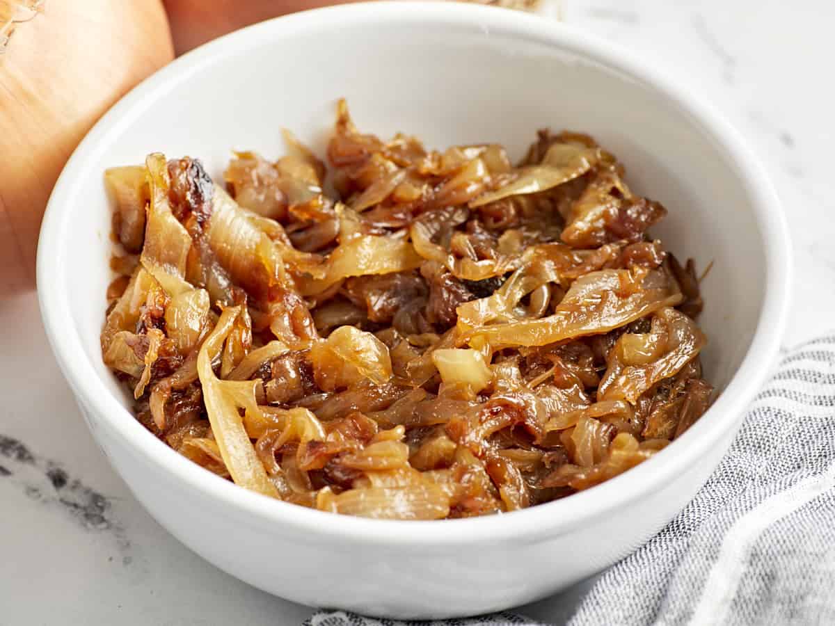 Side view of caramelized onions in a bowl.