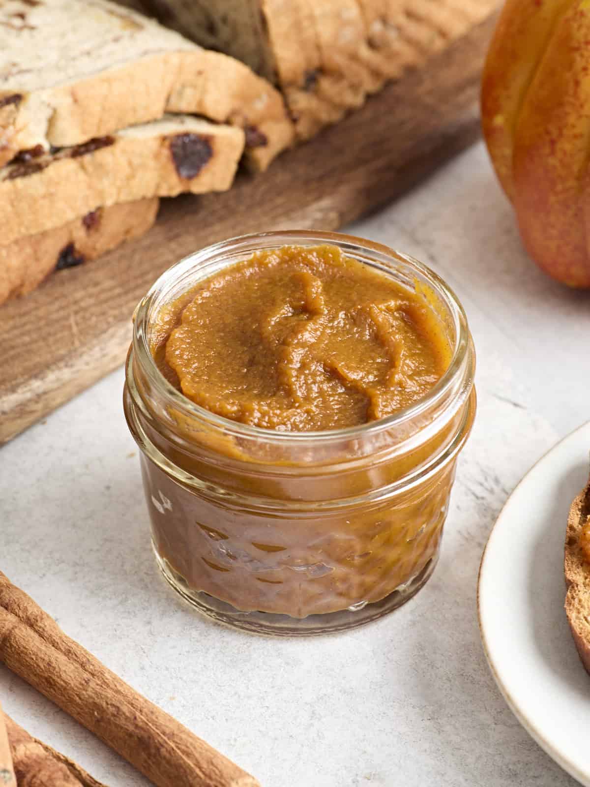 Side view of a jar of pumpkin butter.