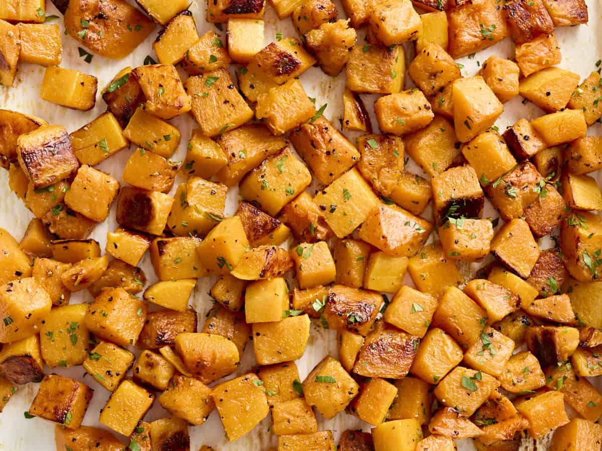 Close up of roasted butternut squash on a baking tray.