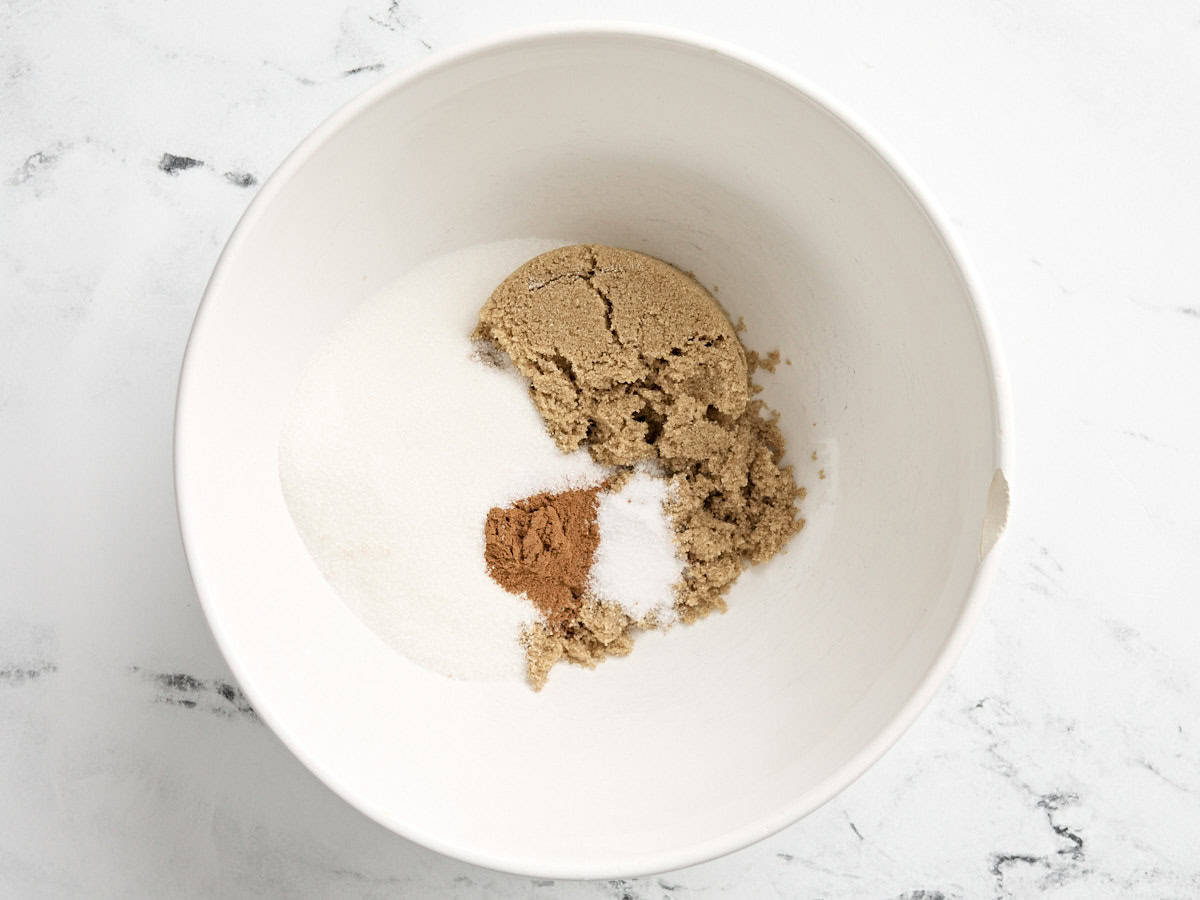 White sugar. brown sugar, and cinnamon in a mixing bowl.