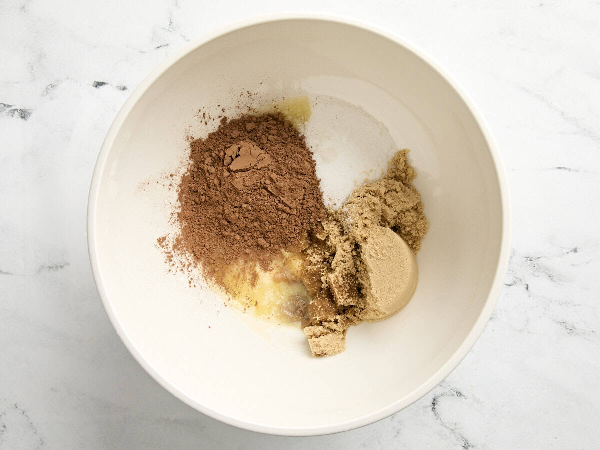 Melted butter, oil, sugar, and cocoa in a mixing bowl.