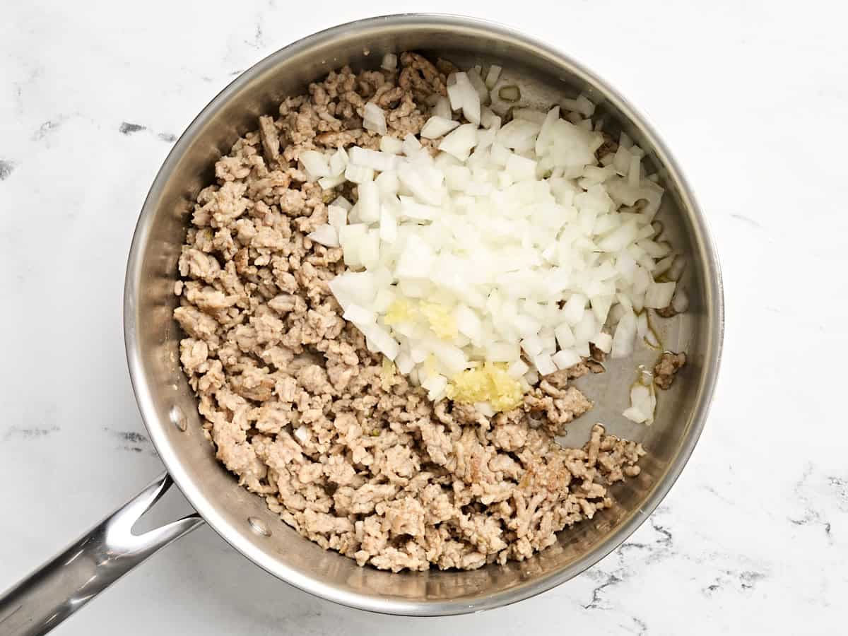 Diced onion and garlic added to sausage skillet.