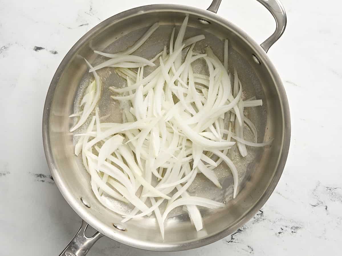 Sliced onions in a skillet.