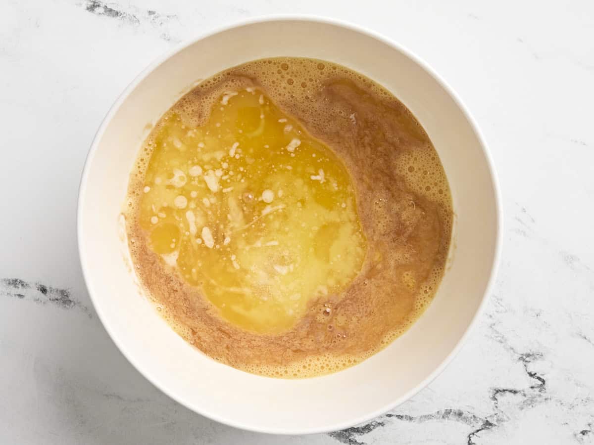 Melted butter and beaten eggs in a mixing bowl.