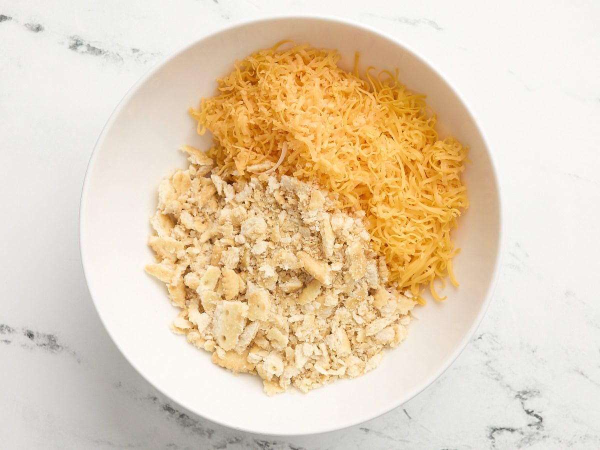 Crushed ritz and shredded cheese in a bowl.