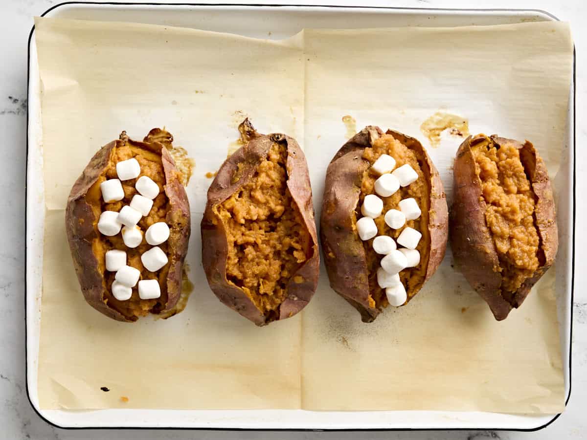 Stuffed twice baked sweet potatoes on a baking sheet.