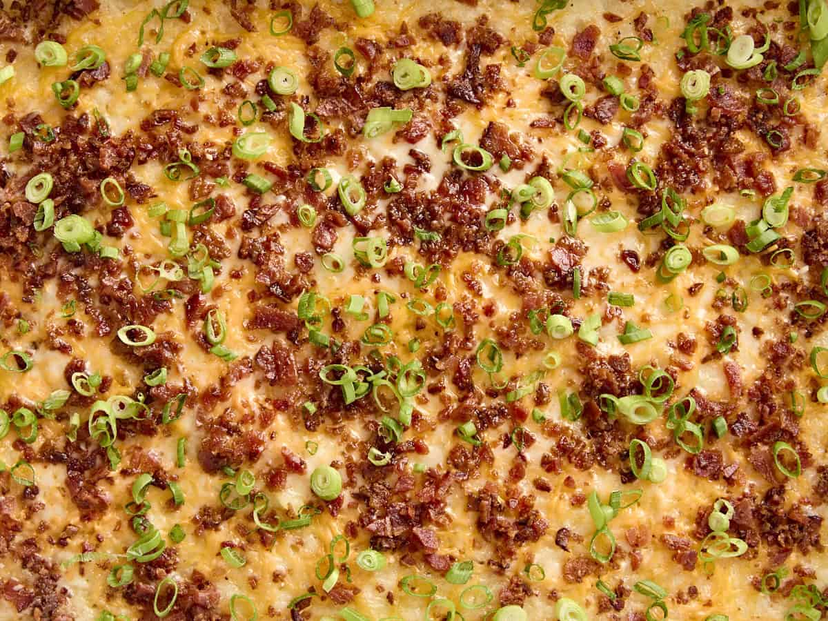 Overhead close up of mashed potato casserole topped with bacon and green onions.