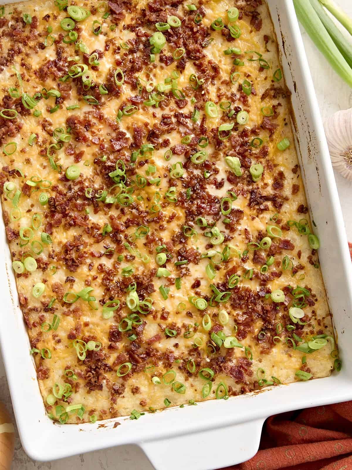 Overhead view of mashed potato casserole in a white baking dish.