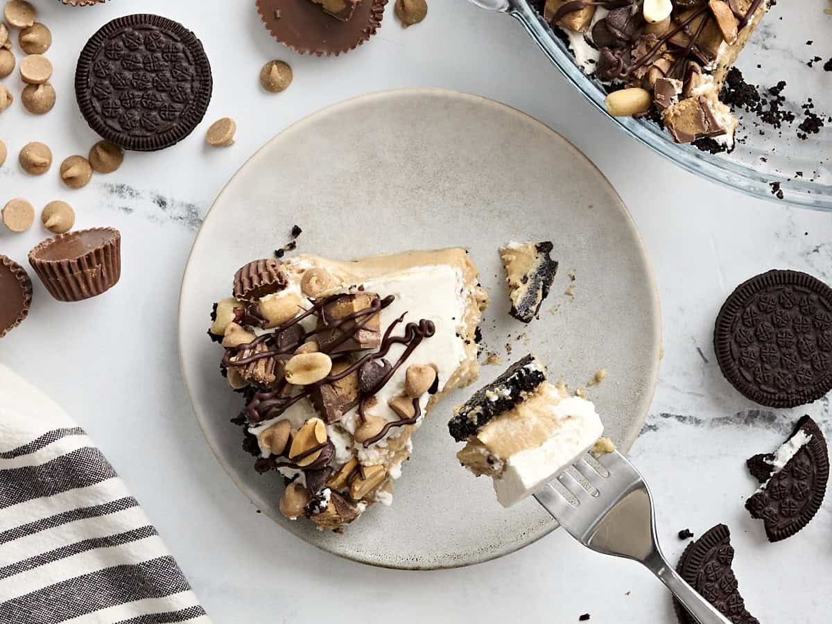 Overhead view of a fork taking some peanut butter pie from a plate.