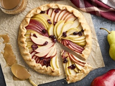 Overhead view of a pear galette with a slice cut out.