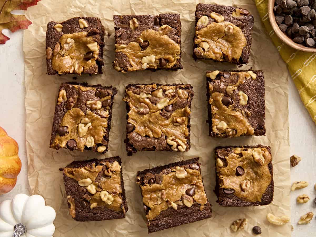 Overhead view of pumpkin brownies on parchment paper.