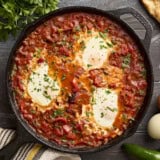 Overhead view of shakshuka in a cast iron skillet.