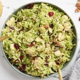 Overhead view of a shaved brussels sprouts salad in a serving bowl.