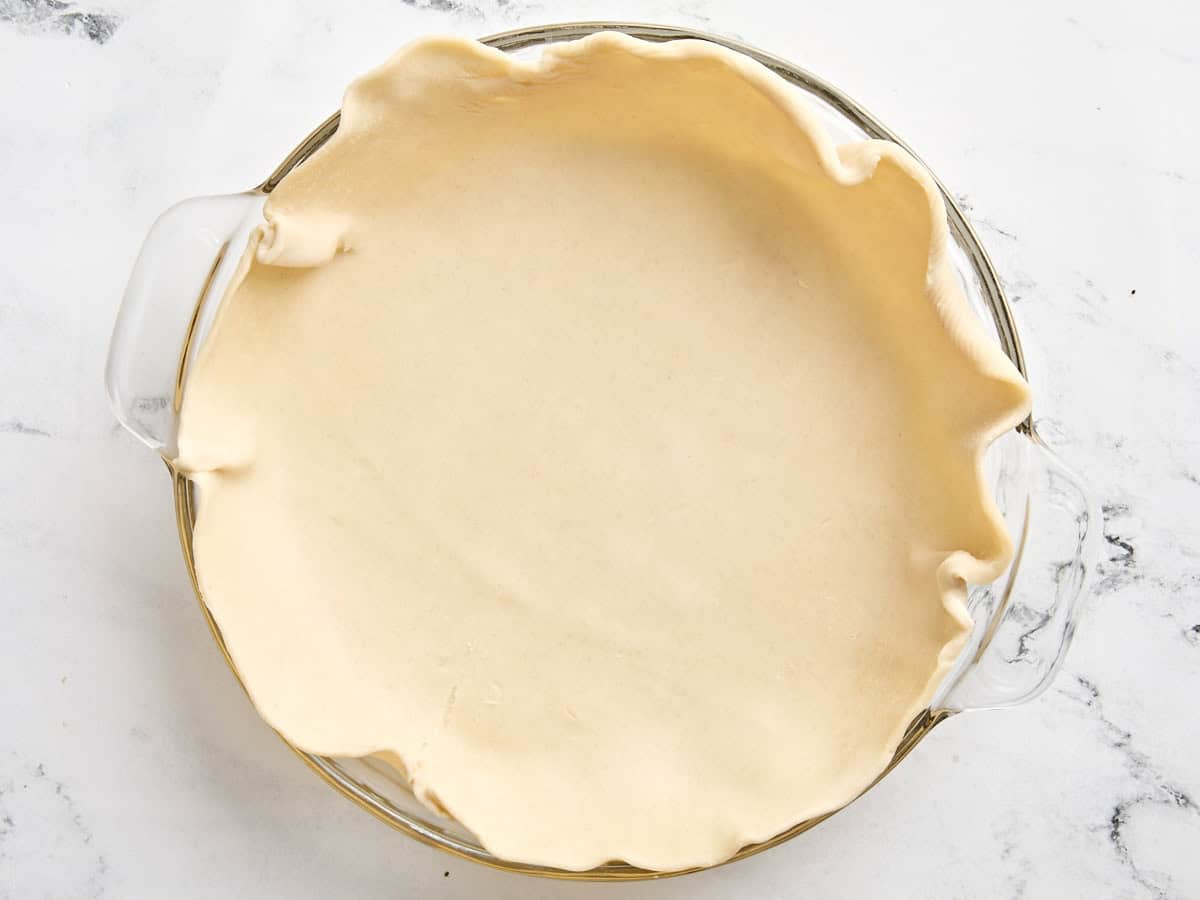 A rolled out pie crust in a pie dish.