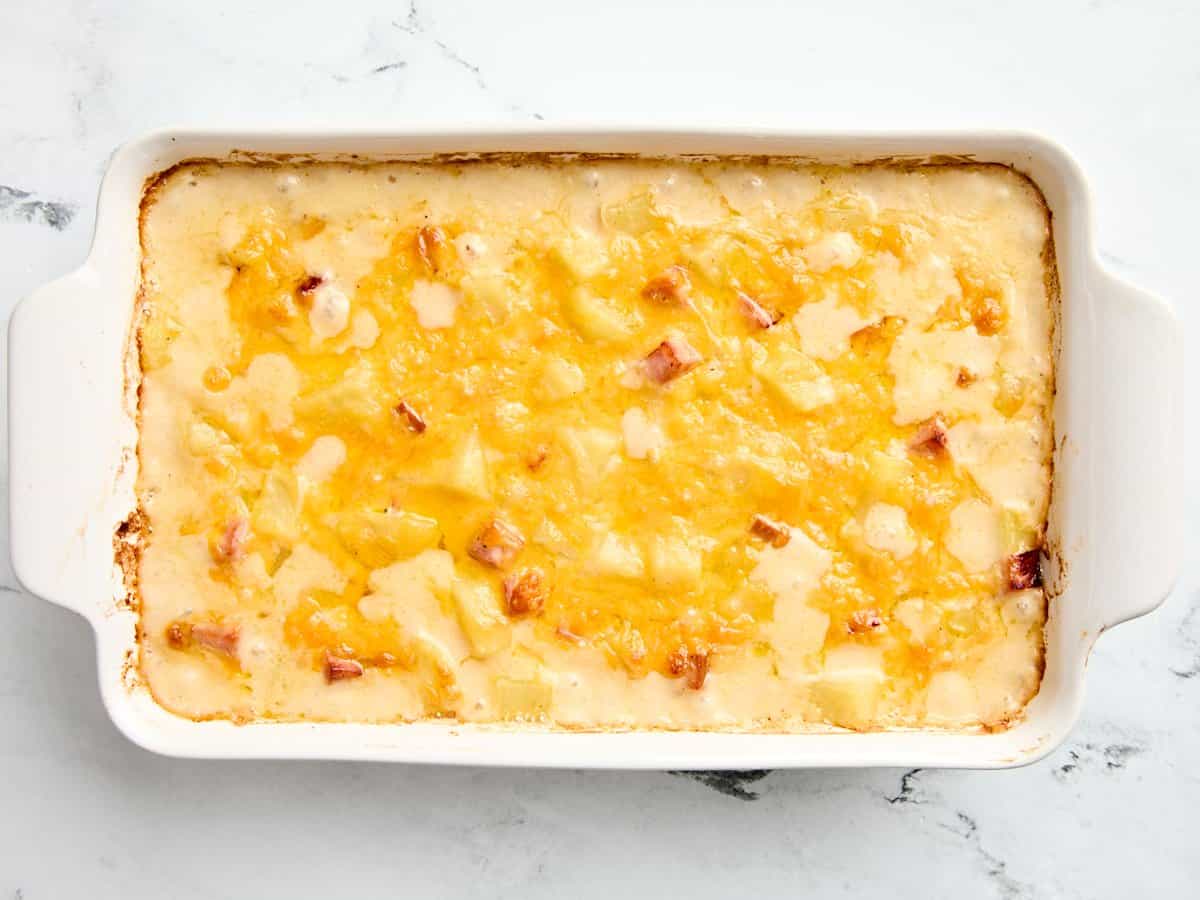 Freshly baked ham and cheese casserole in a baking dish.