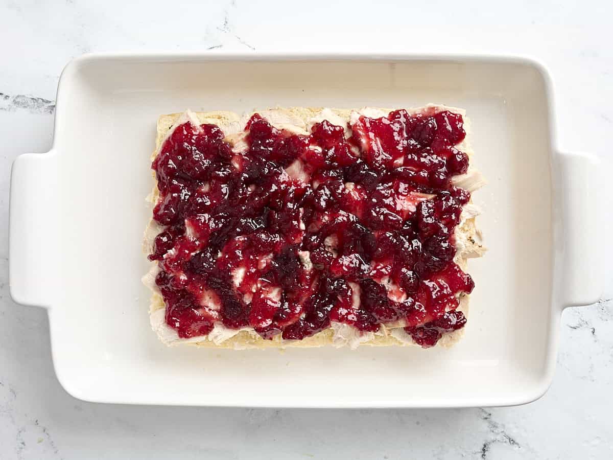 Cranberry sauce added to turkey slider rolls on top of the turkey.