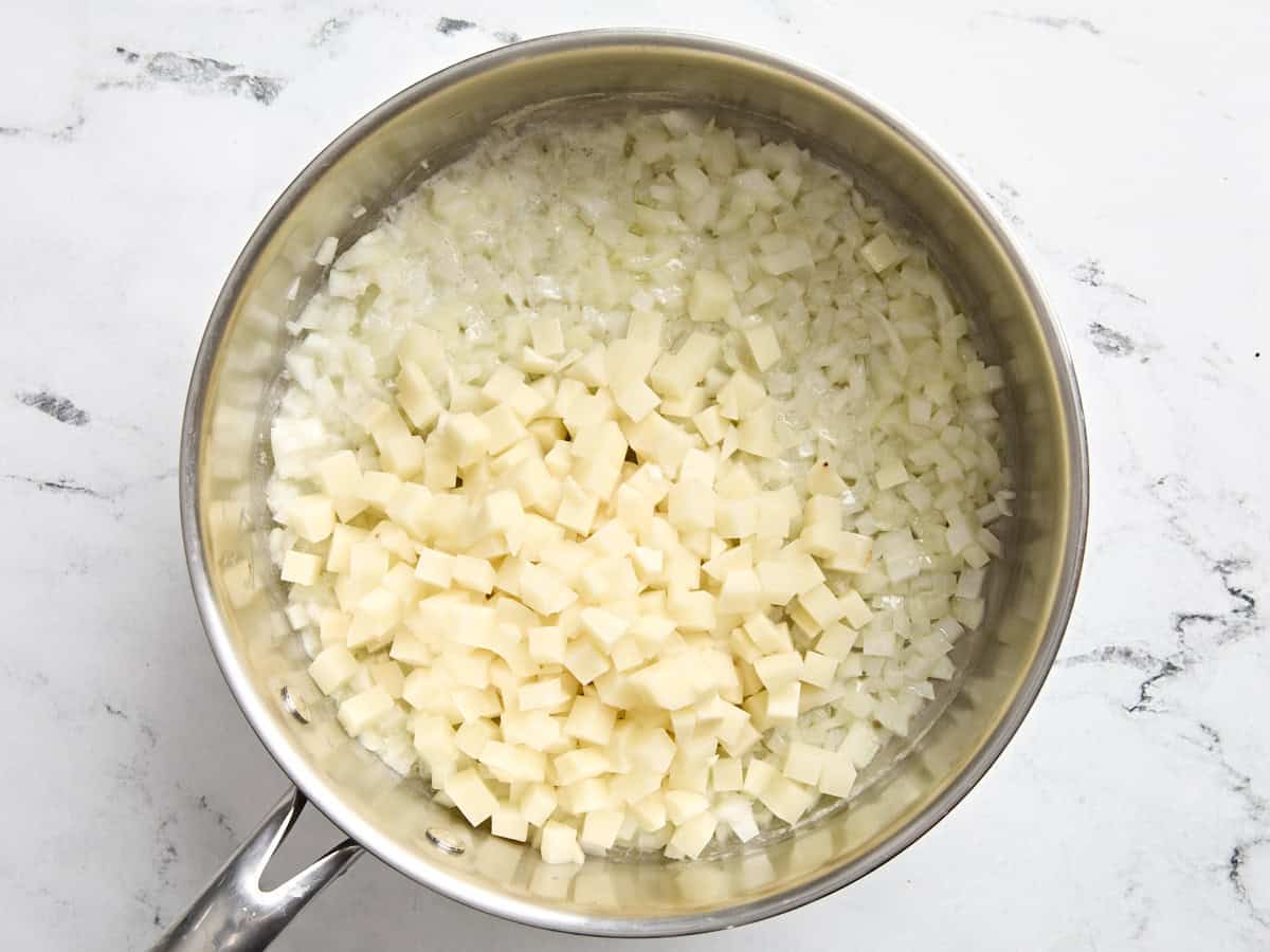 Diced potatoes added to pan with onions and melted butter.