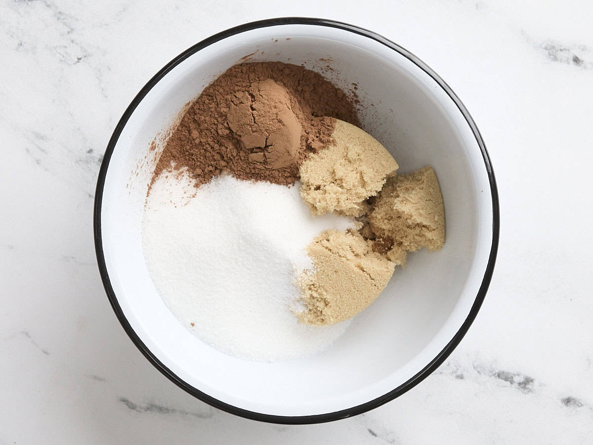 Granulated sugar, brown sugar. and cocoa powder in a mixing bowl.