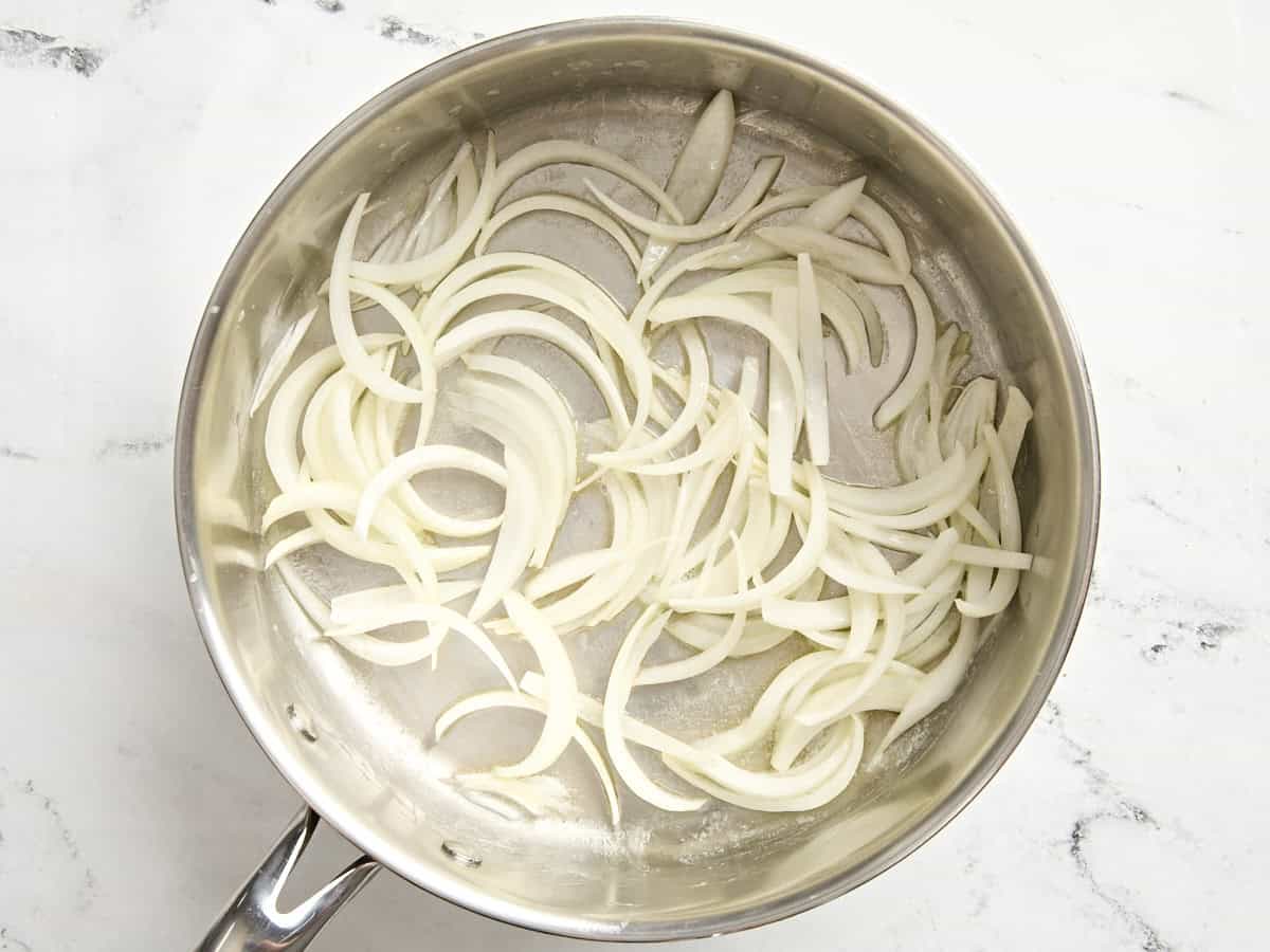 Sliced onions in a skillet.