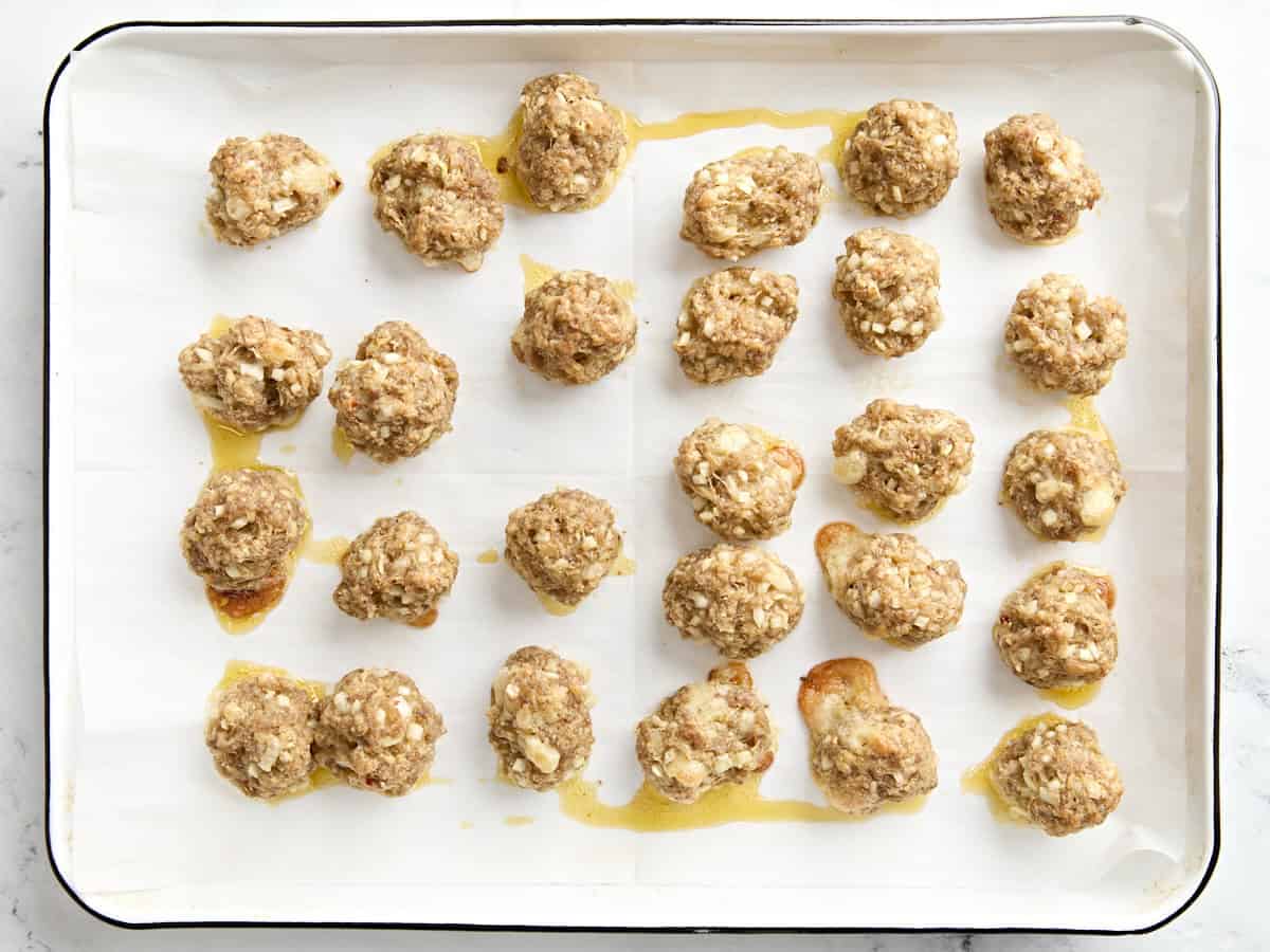 Finished sausage balls on a parchment lined baking sheet.