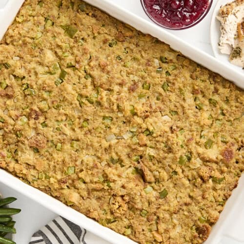 Overhead view of cornbread dressing in a large white baking dish.