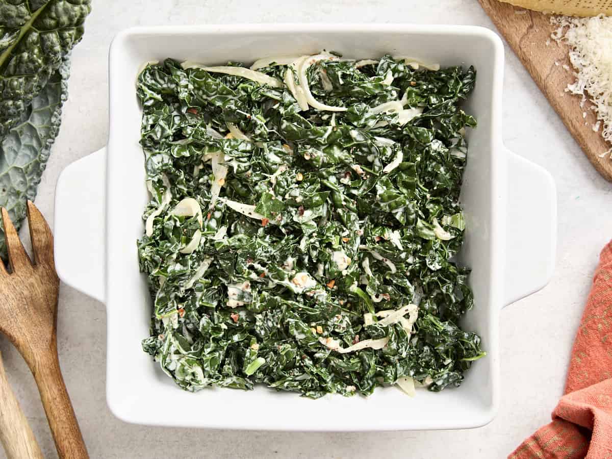 Overhead view of creamed kale in a square-shaped dish.