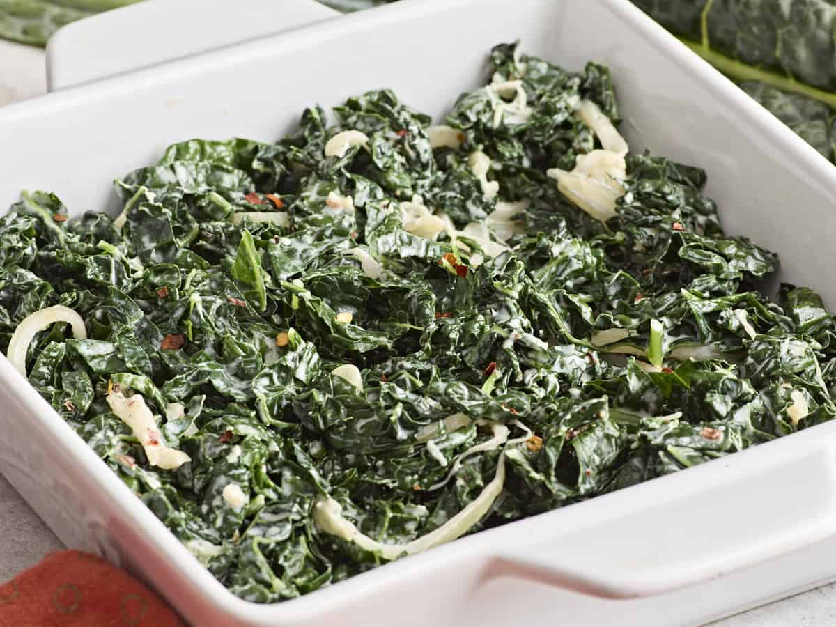 Side view of creamed kale in a squash-shaped serving platter.