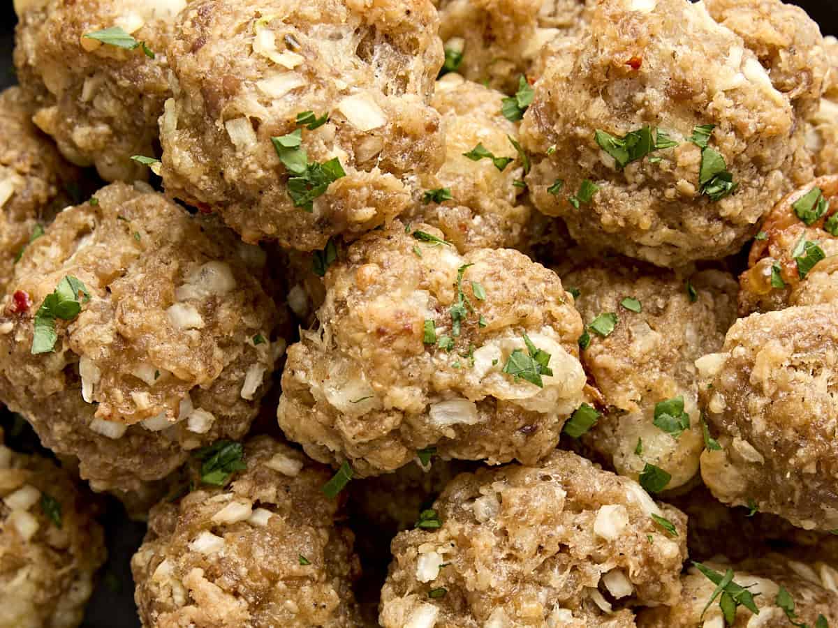 Close up of sausage balls garnished with minced parsley.