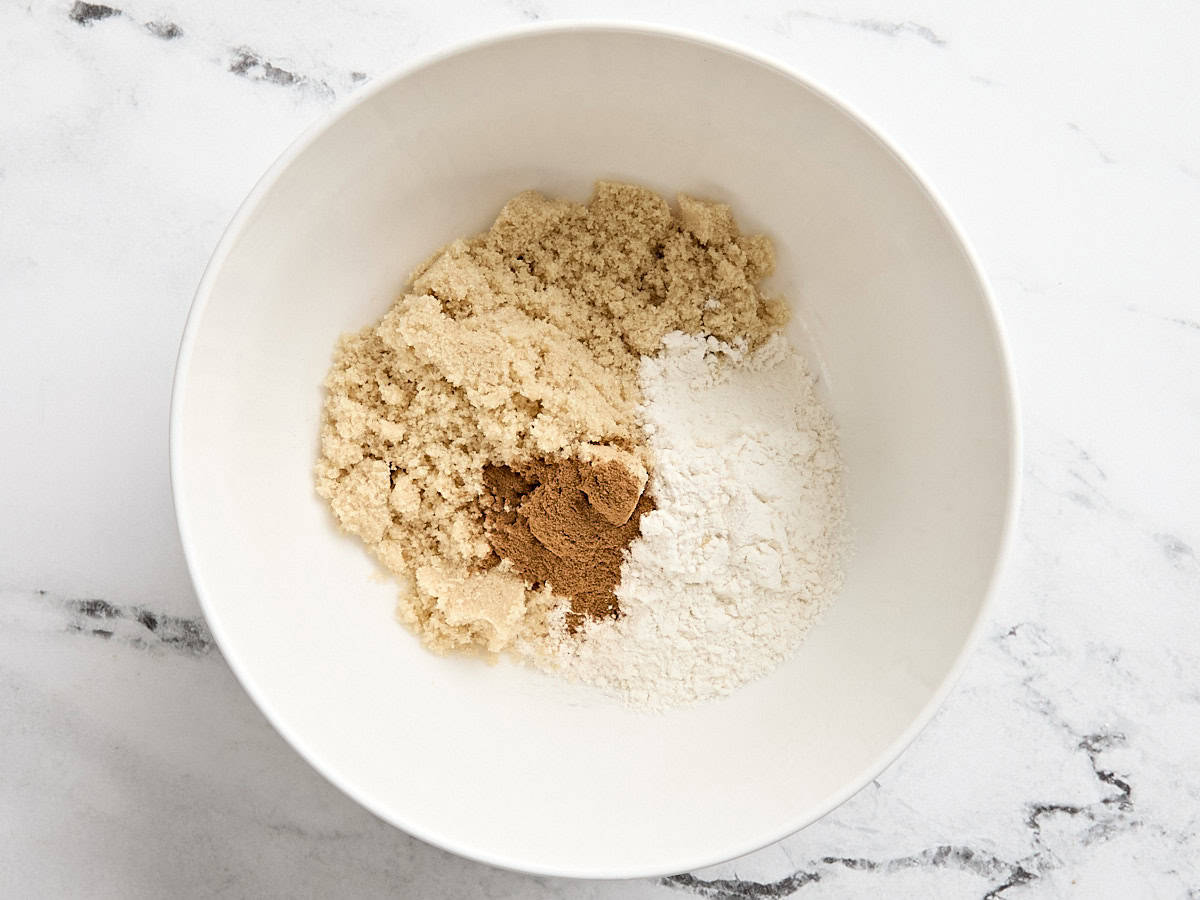 Dry ingredients for apple cinnamon muffins in a mixing bowl.