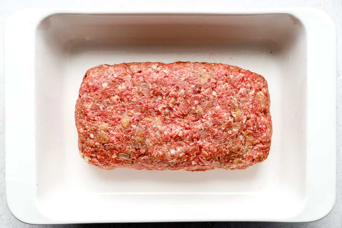 A formed meatloaf in a baking dish.