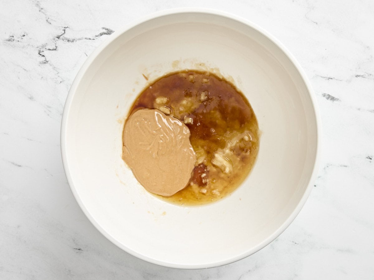 Peanut butter, maple syrup, and brown sugar in a mixing bowl.