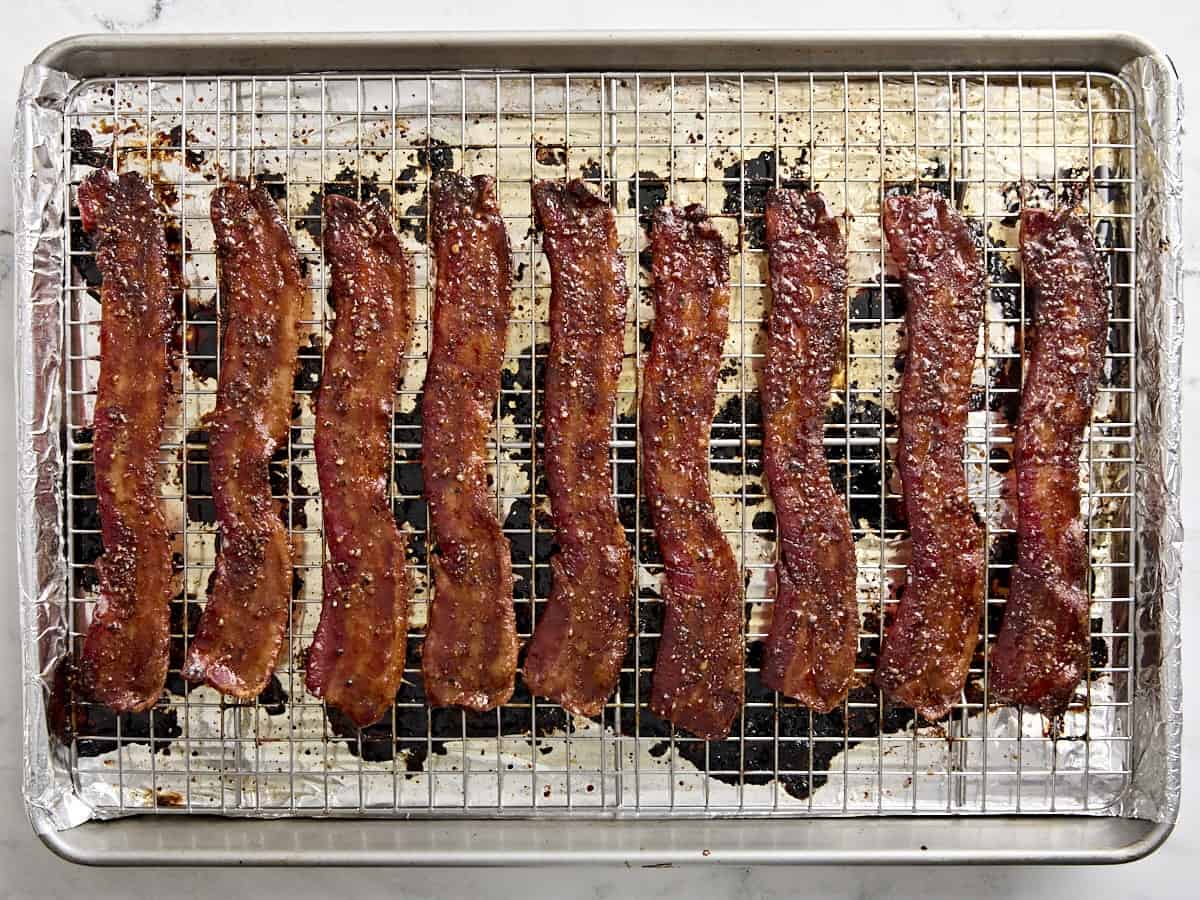 Candied bacon on a wire rack over a baking sheet.