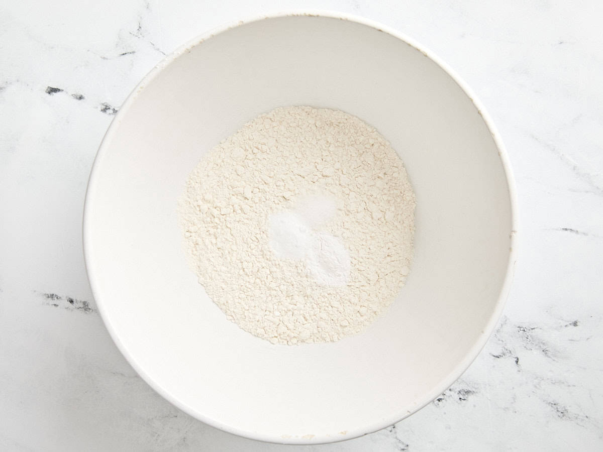 Flour, baking soda, and baking powder in a mixing bowl.