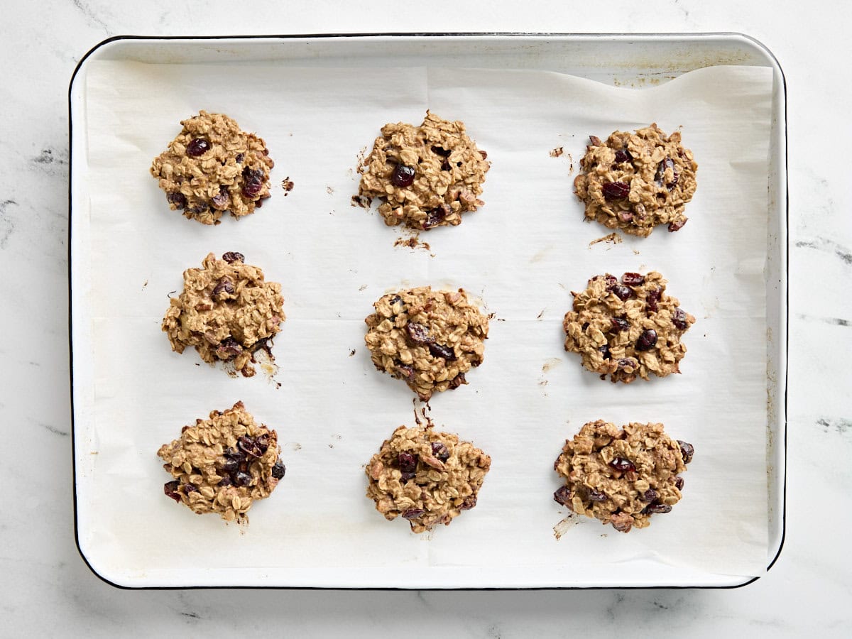 Freshly baked breakfast cookies on a parchment lined baking sheet.