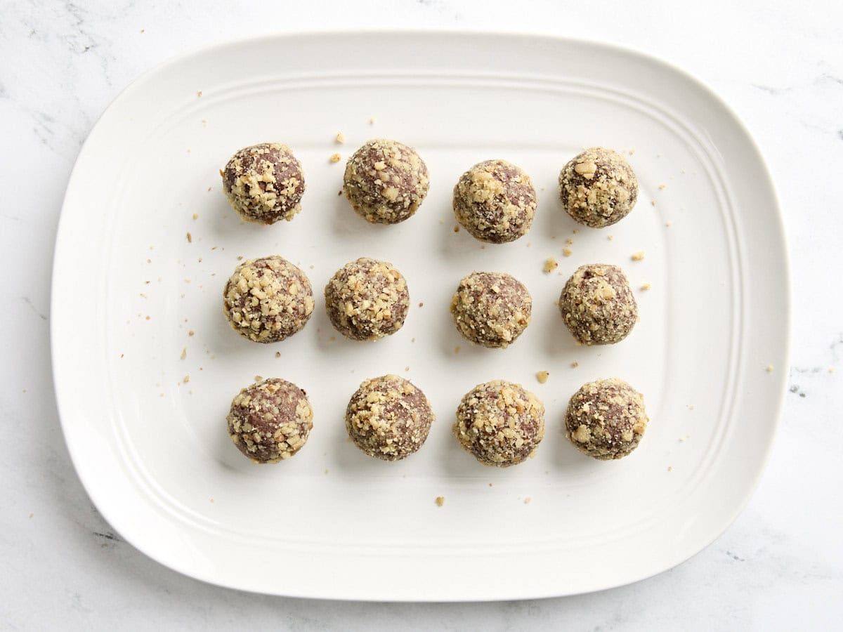 Walnut chocolate truffles on a plate.