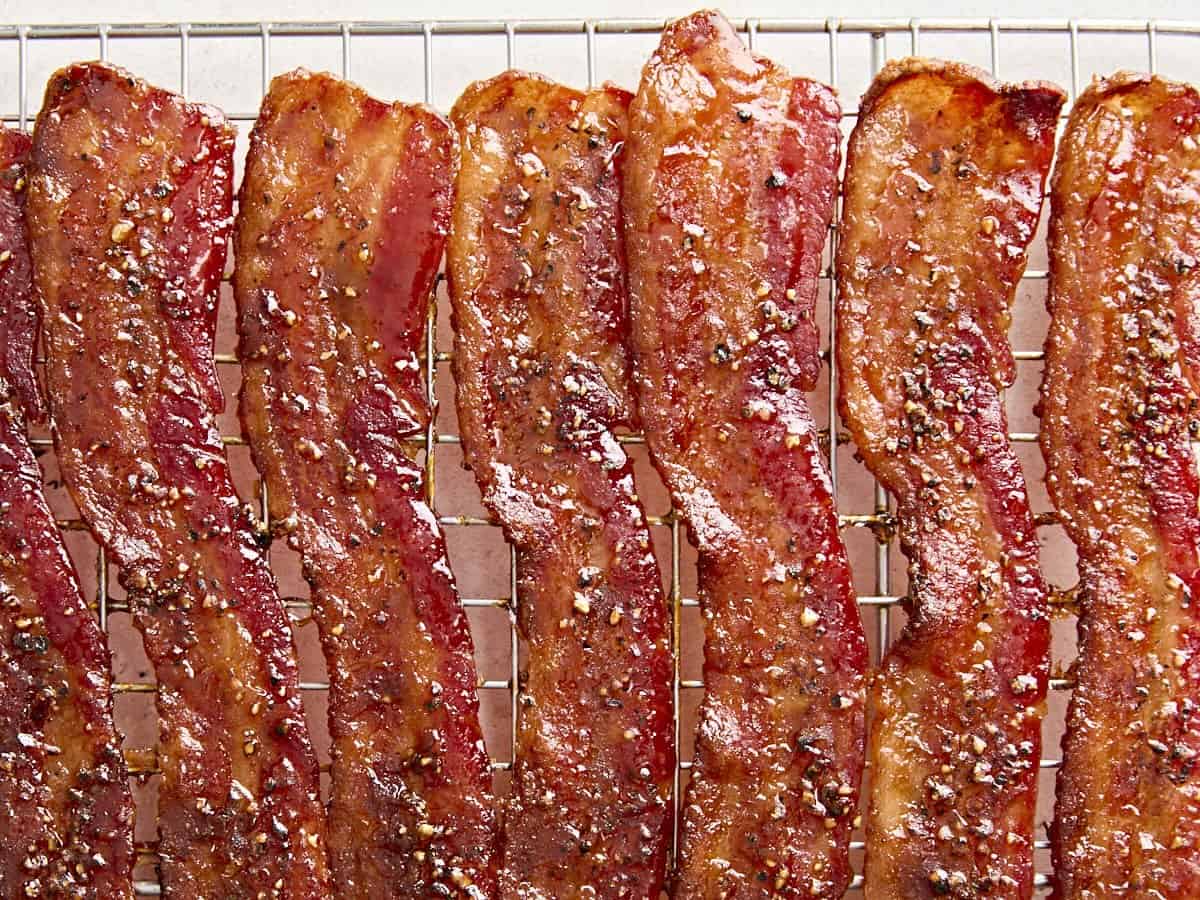 Close up of candied bacon on a wire rack.