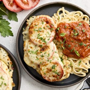 Overhead view of cauliflower parmesan on a plate with noodles and marinara sauce.