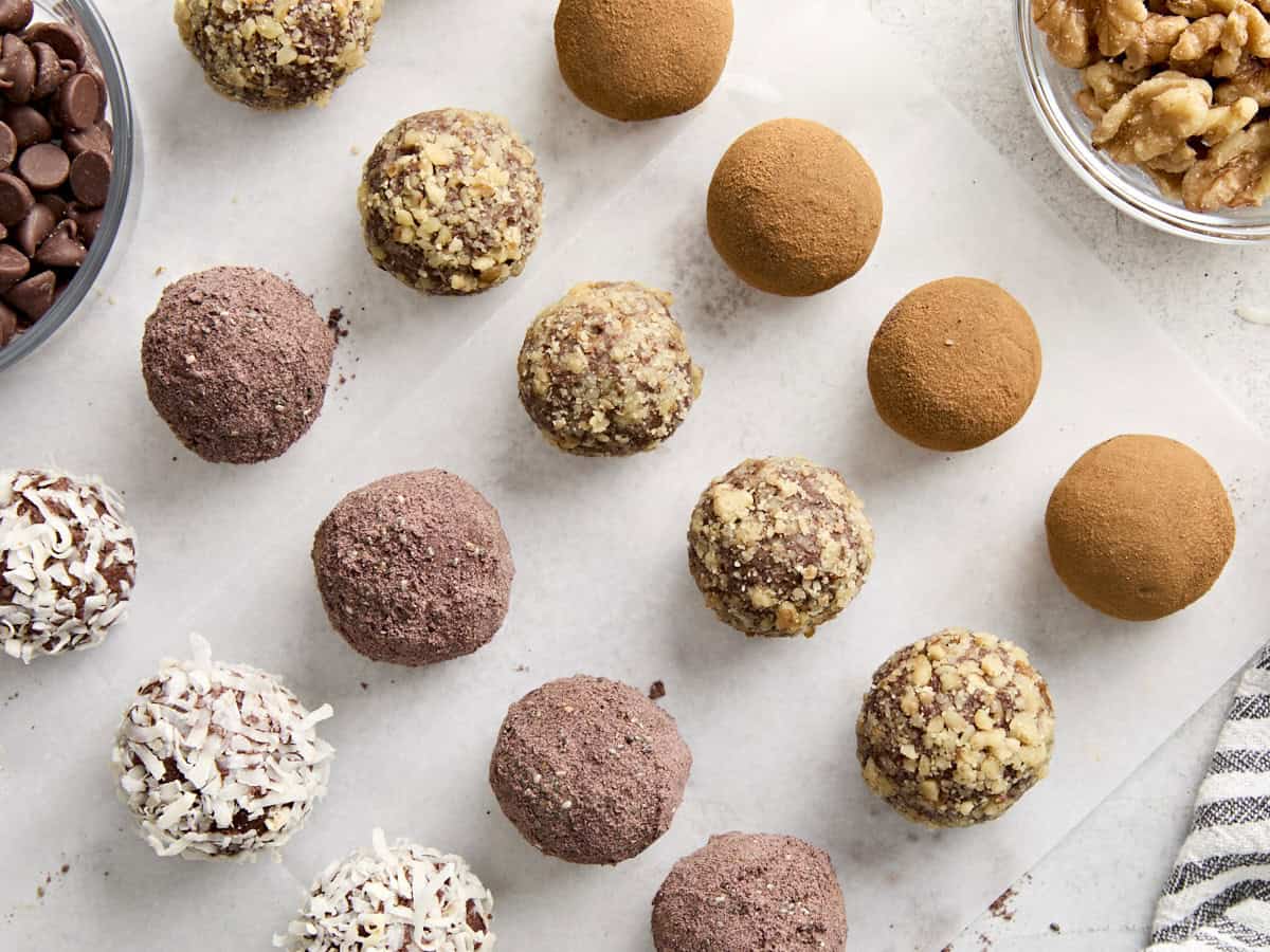 Overhead view of chocolate truffles with various toppings.