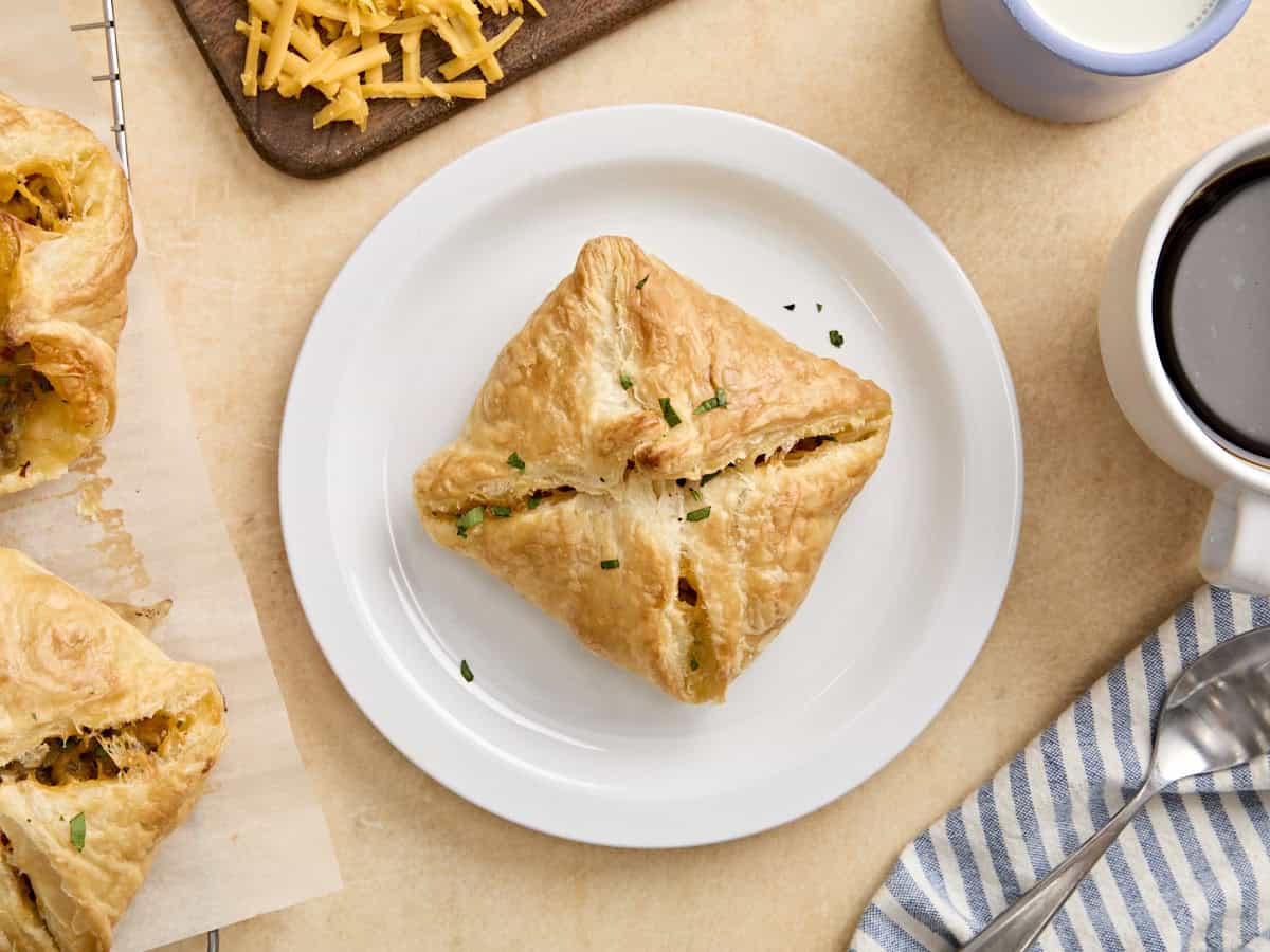 Overhead view of a sausage and cheese hand pie on a plate.