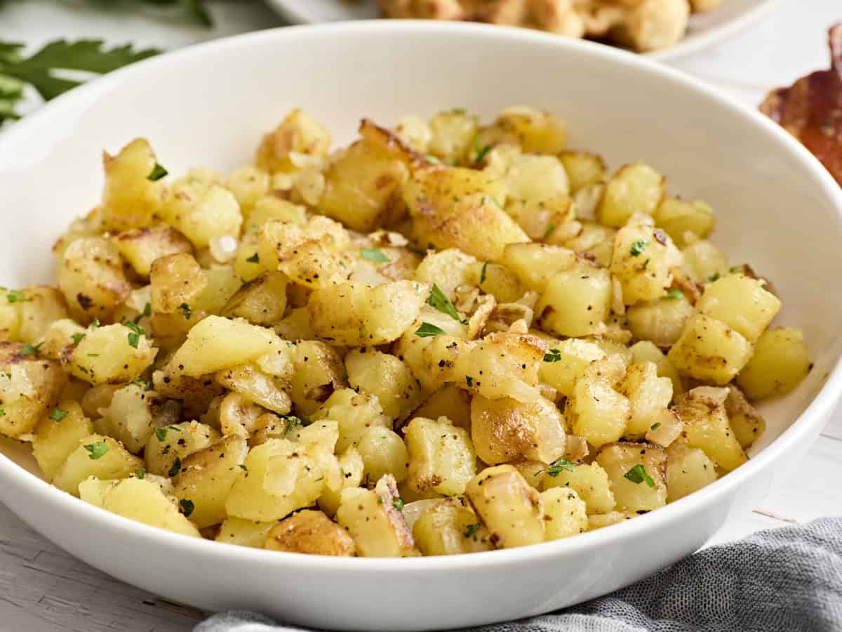 Side view of skillet breakfast potatoes in a bowl.