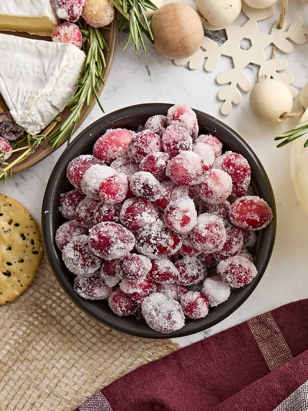 Overhead view of a bowl of sugared cranberries.