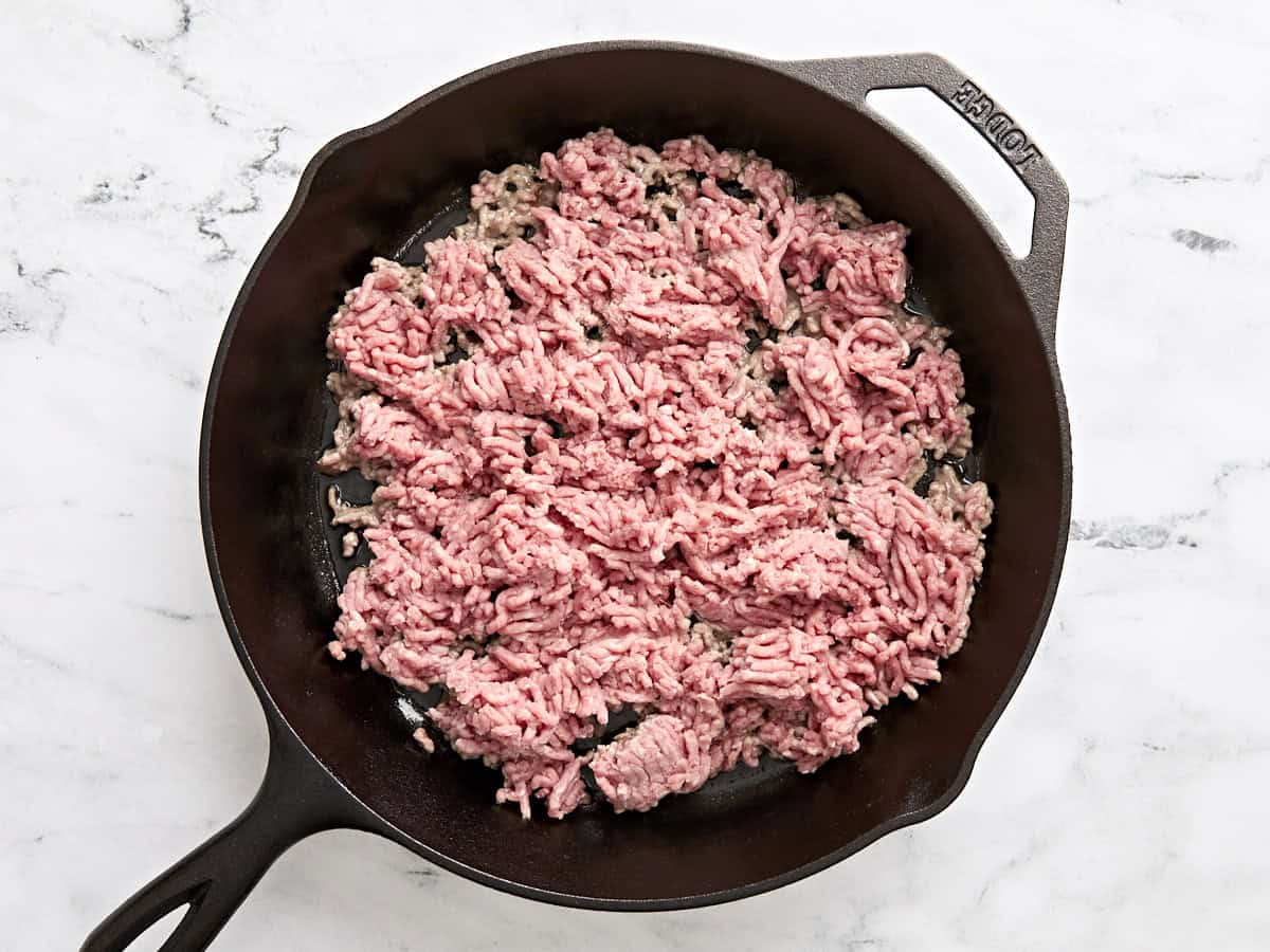 Ground beef in a skillet.