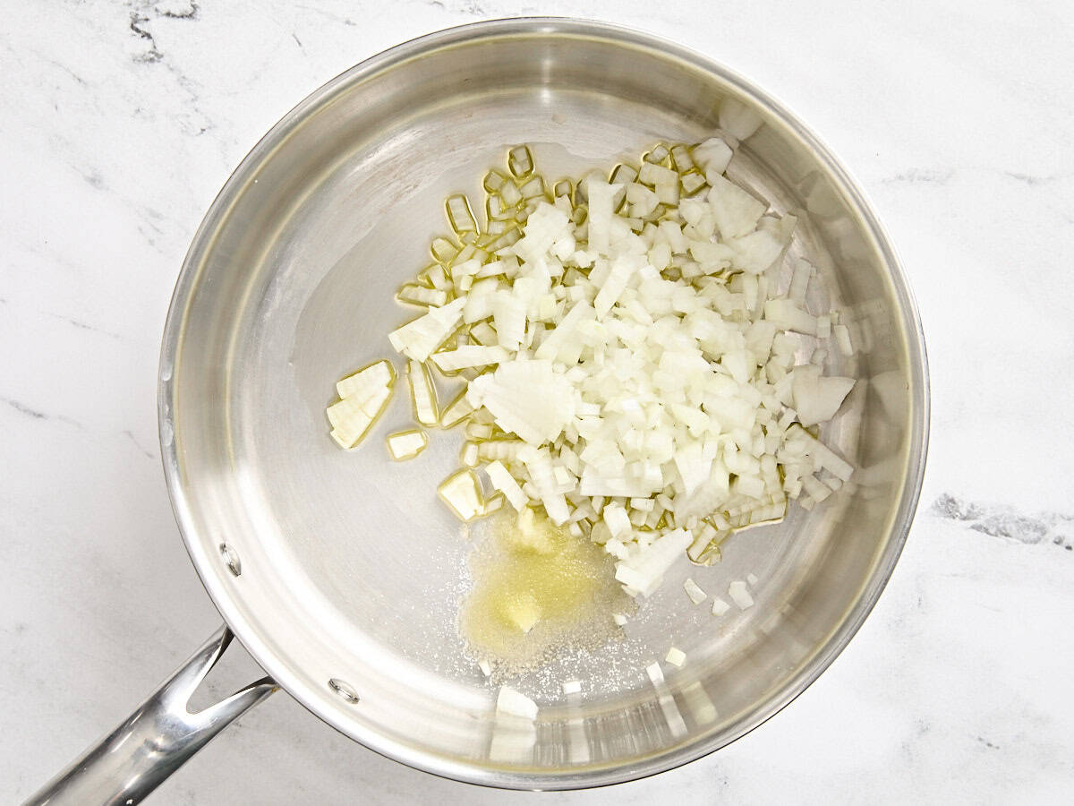 Minced onion in a skillet with oil.