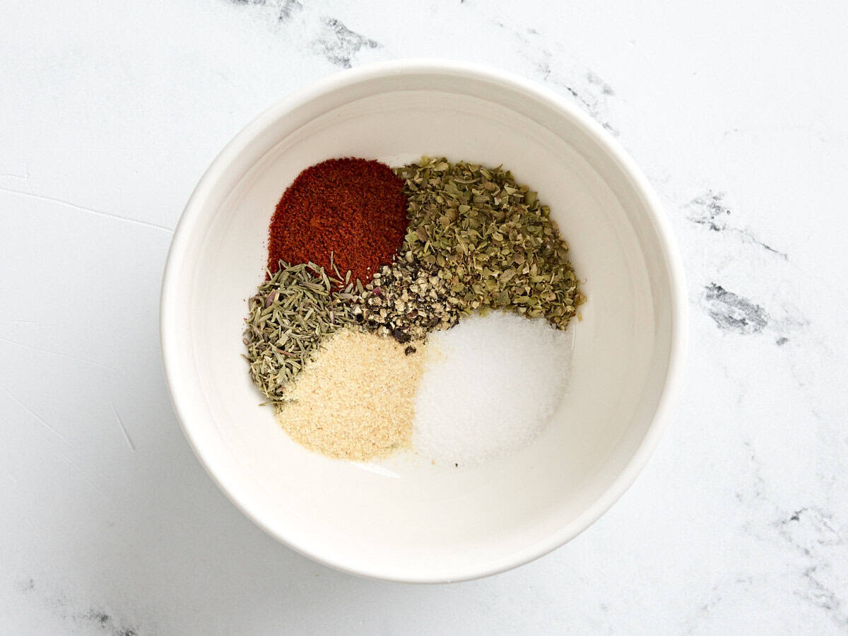 The seasonings for Greek chicken and orzo in a bowl.