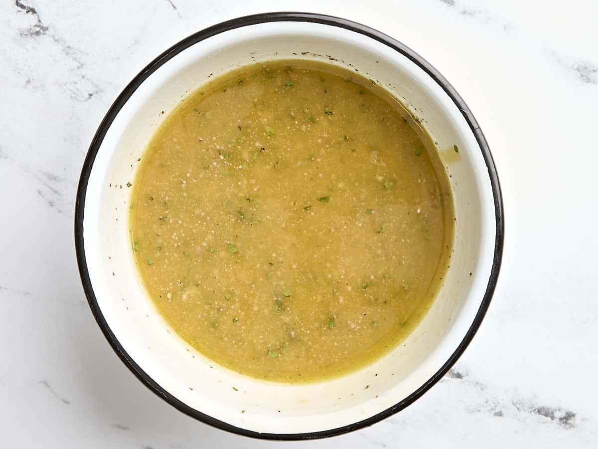 Overhead view of greek salad dressing in a bowl.