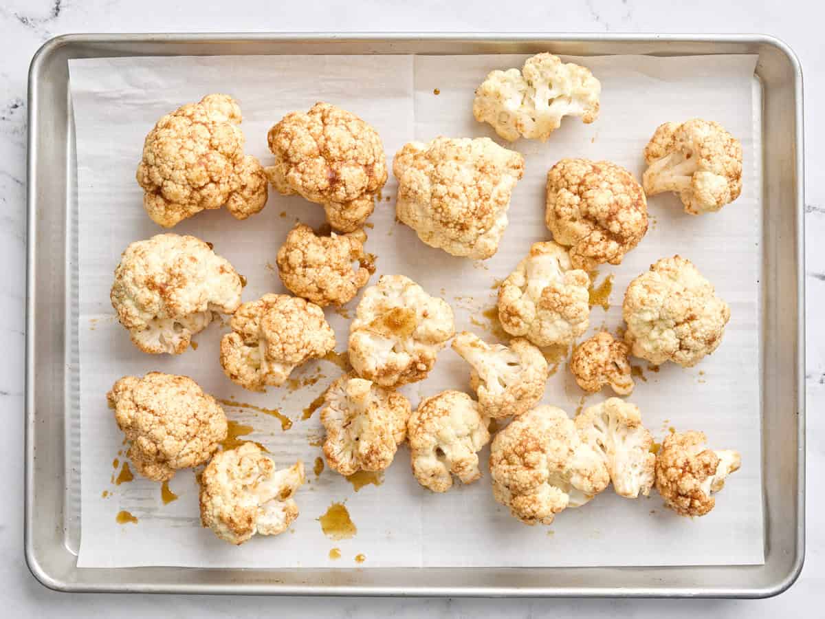 Buffalo cauliflower wings on a baking sheet.