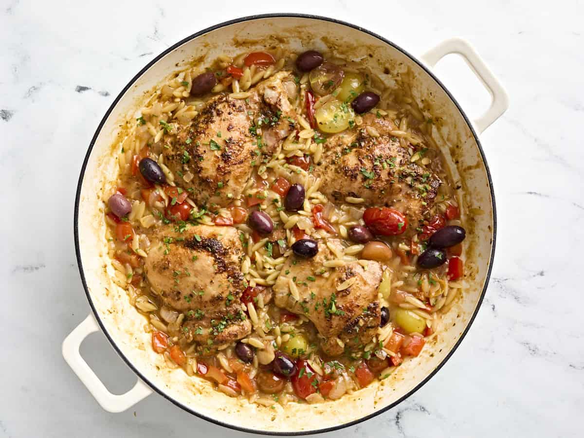 Greek chicken and orzo in a skillet.