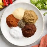 Ingredients for homemade fajita seasoning on a plate.